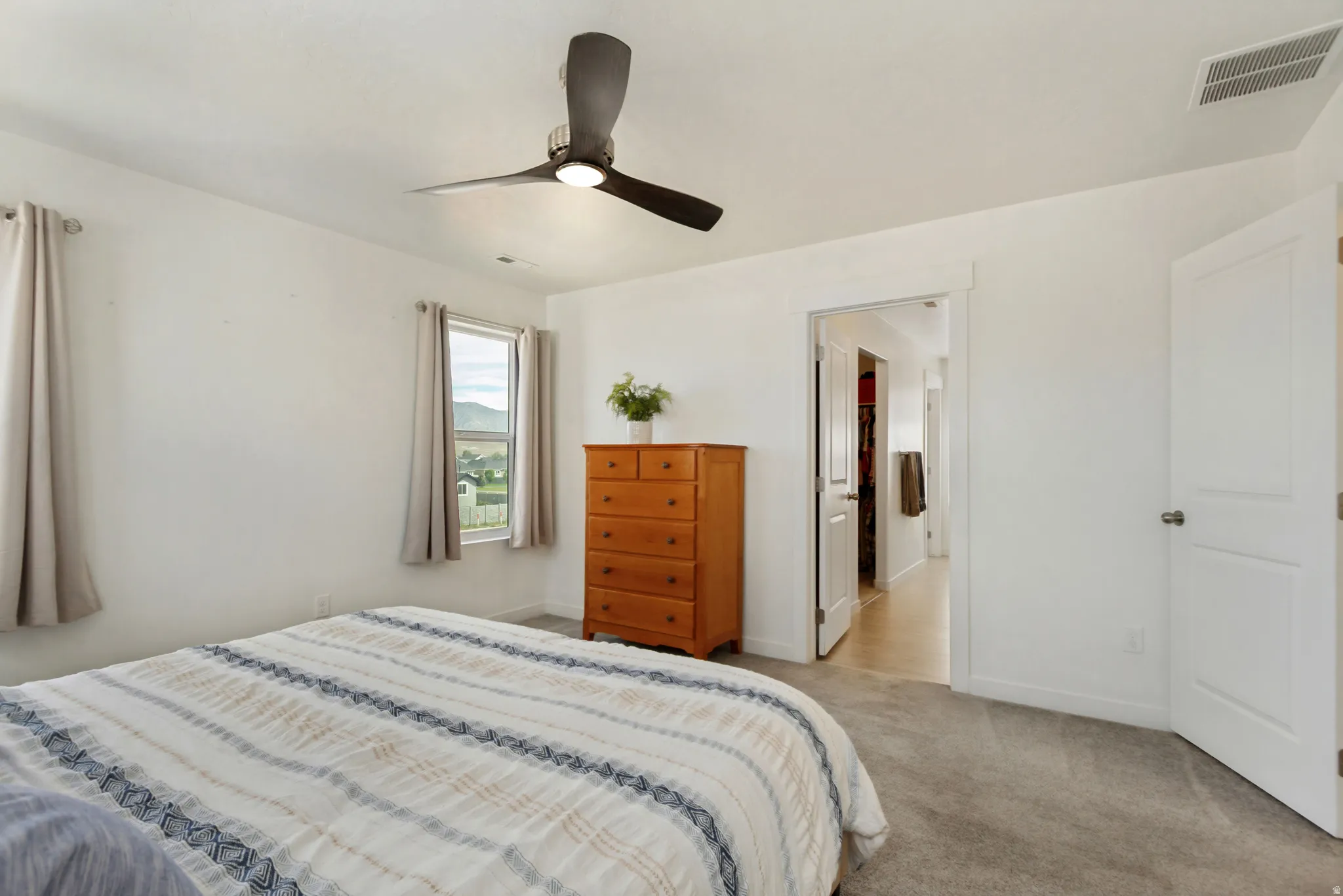 Recessed lighting, ceiling fan, white paneled doors, light grey carpeting, and white walls