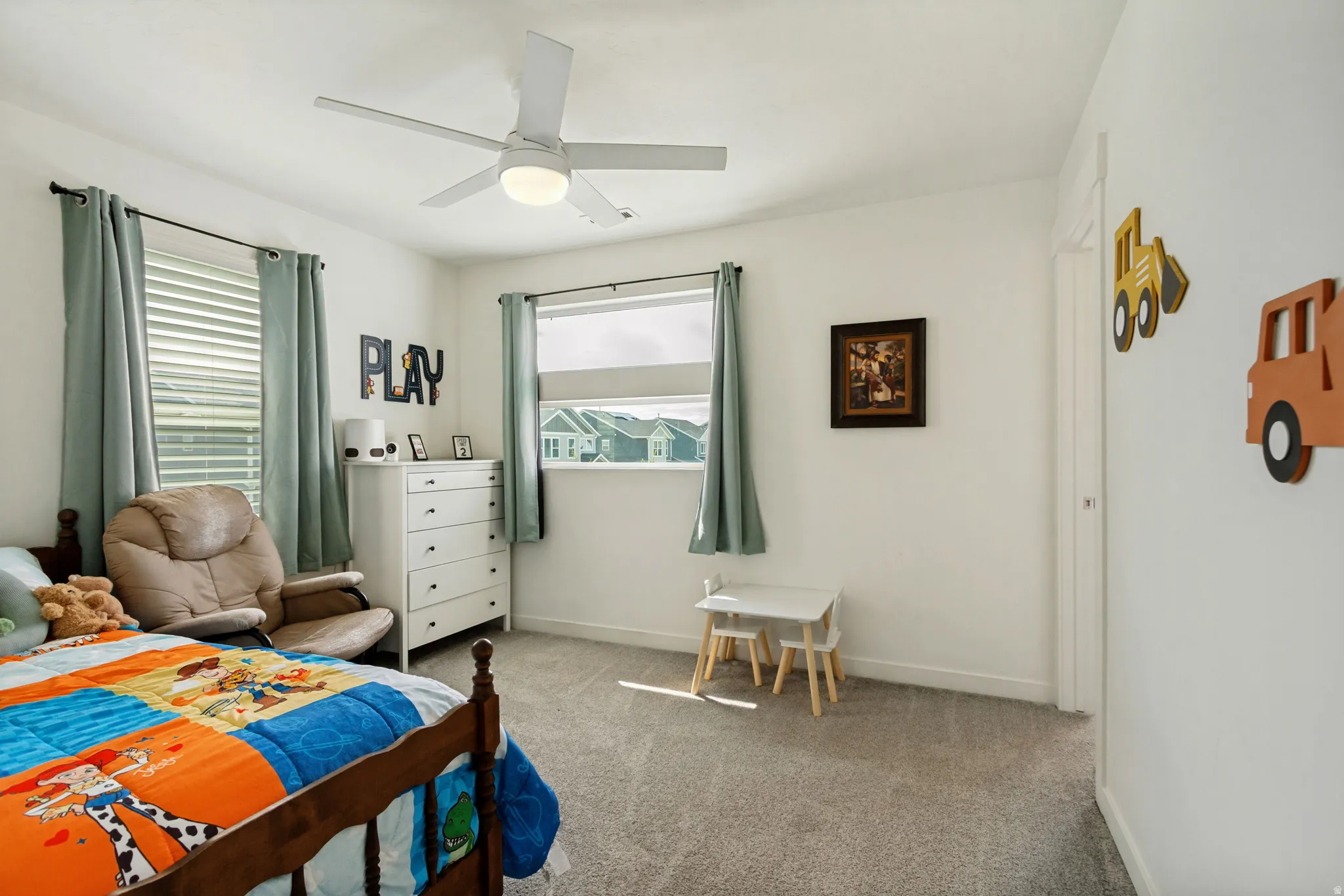 Recessed lighting, ceiling fan, two windows with blinds, and carpeted flooring