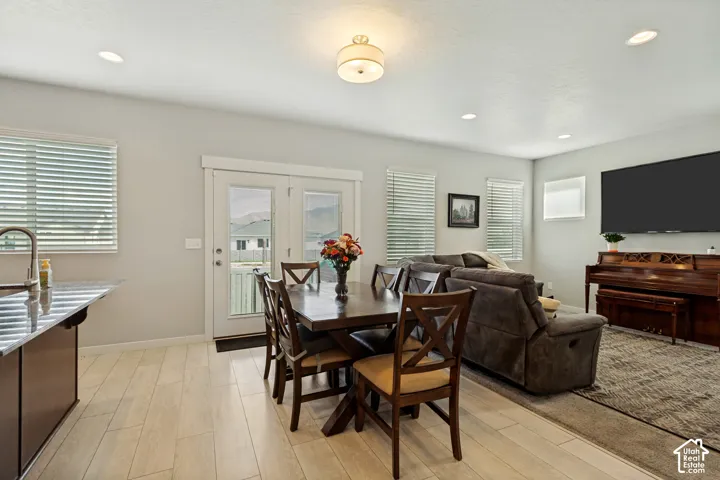 Open-concept living space featuring wood-finish flooring, recessed lighting, and a neutral color palette