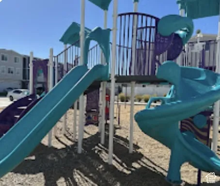 Recreational playground structure featuring multiple slides, stairs, and climbing elements