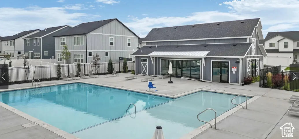 Community pool featuring a large swimming area, an integrated shallow pool, and a surrounding concrete deck
