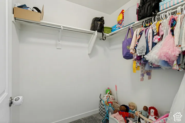 White interior walls with wall-mounted shelving and clothing rods