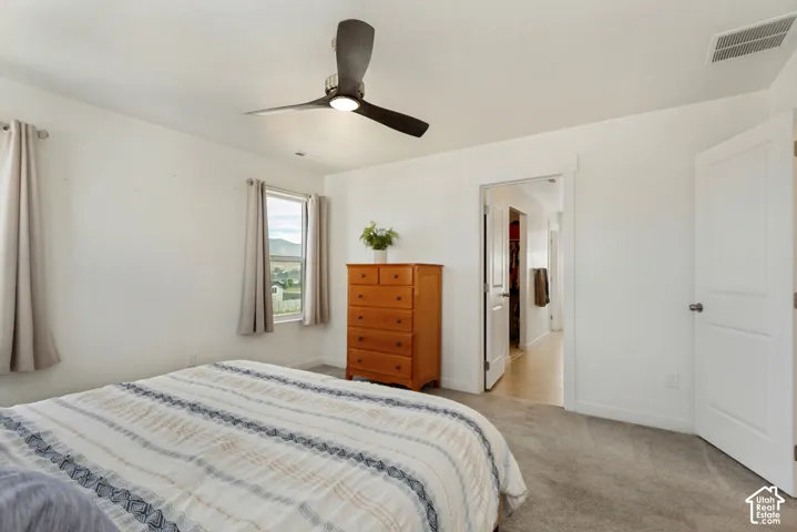 Recessed lighting, ceiling fan, white paneled doors, light grey carpeting, and white walls