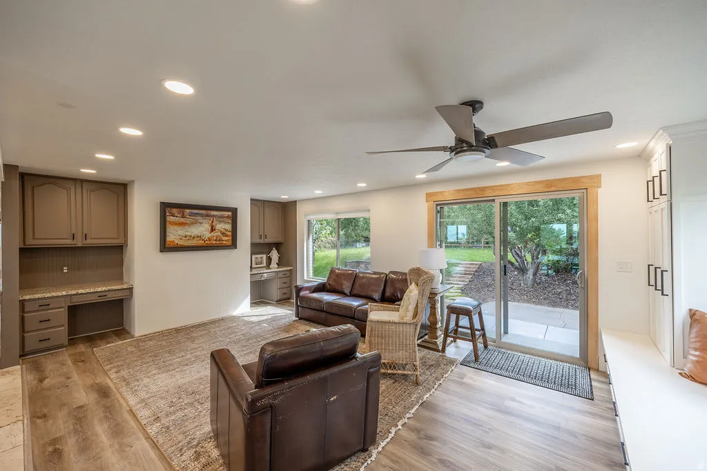 Wood-finish flooring throughout, recessed lighting, and a ceiling fan
