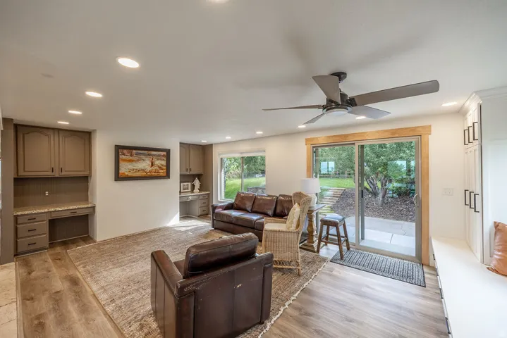 Wood-finish flooring throughout, recessed lighting, and a ceiling fan