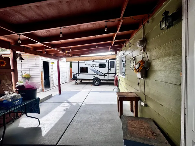 Covered concrete patio with exposed wood beam ceiling