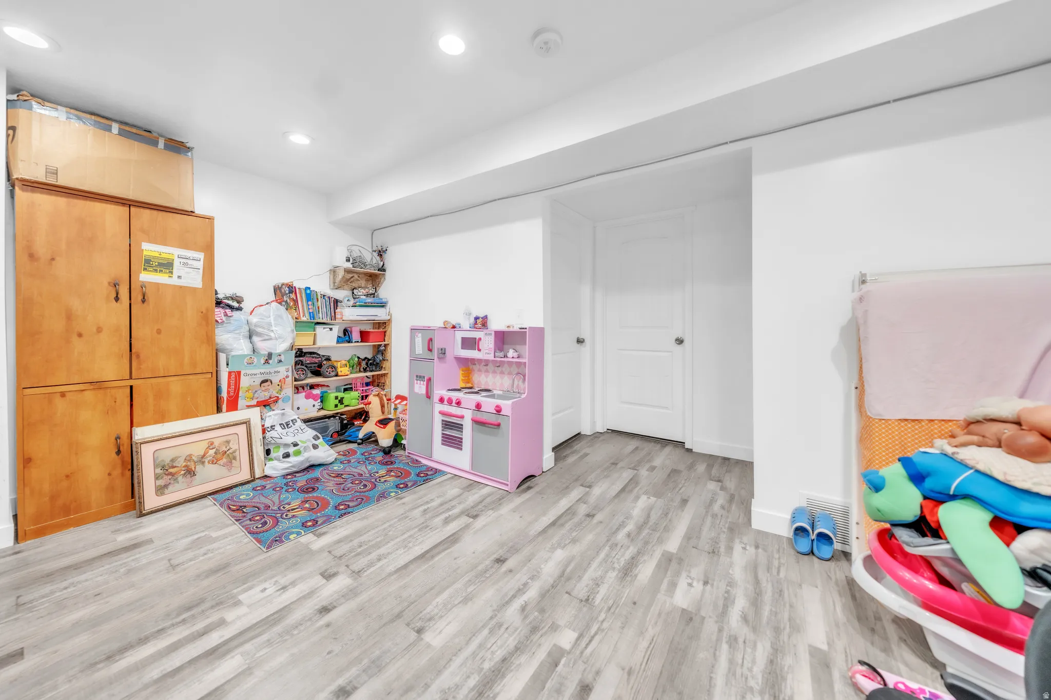 Recessed lighting illuminating wood-finish flooring