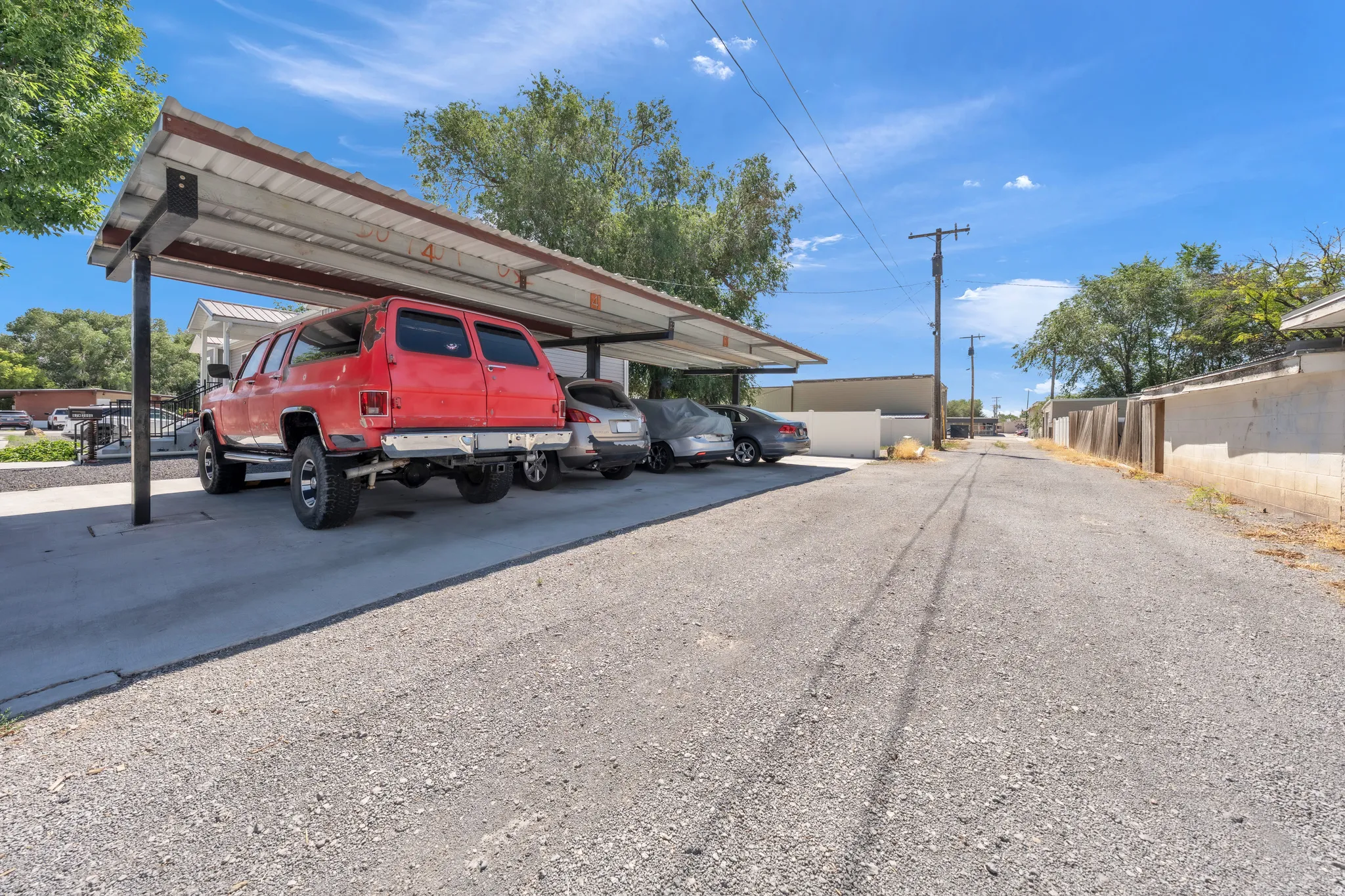 Carport structure with a metal roof and concrete pad
