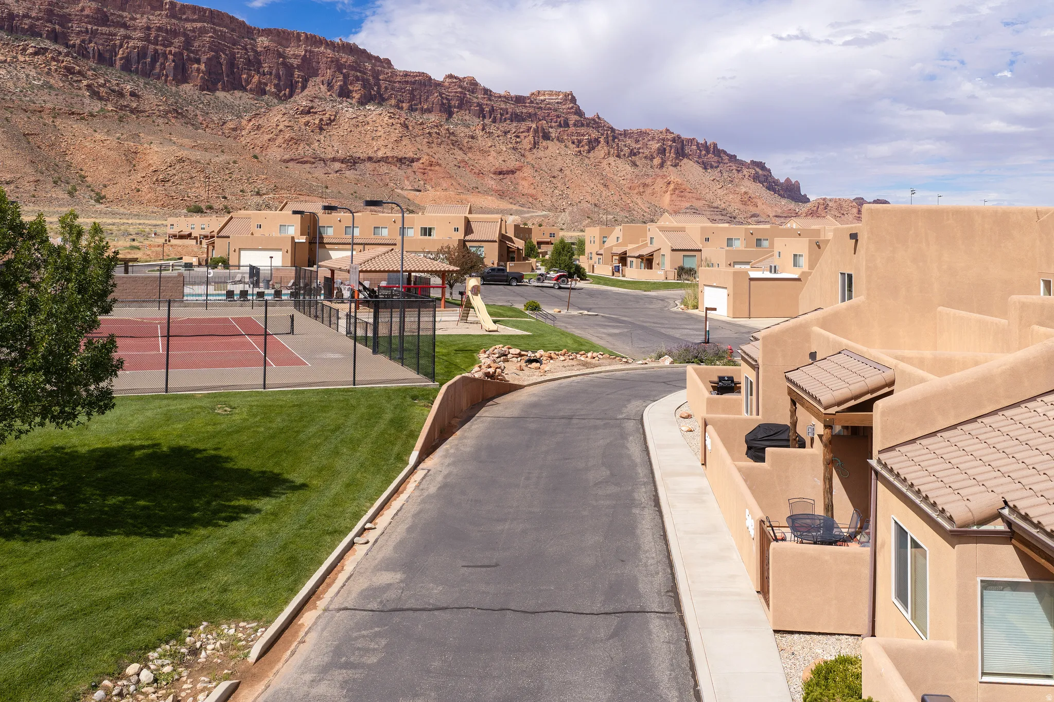 Desert-toned residential complex with tile roofing and stucco exteriors