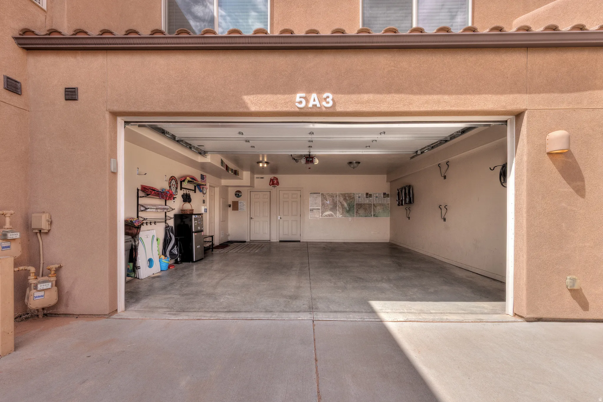 Spacious garage featuring a concrete floor, recessed lighting, and dual interior doors