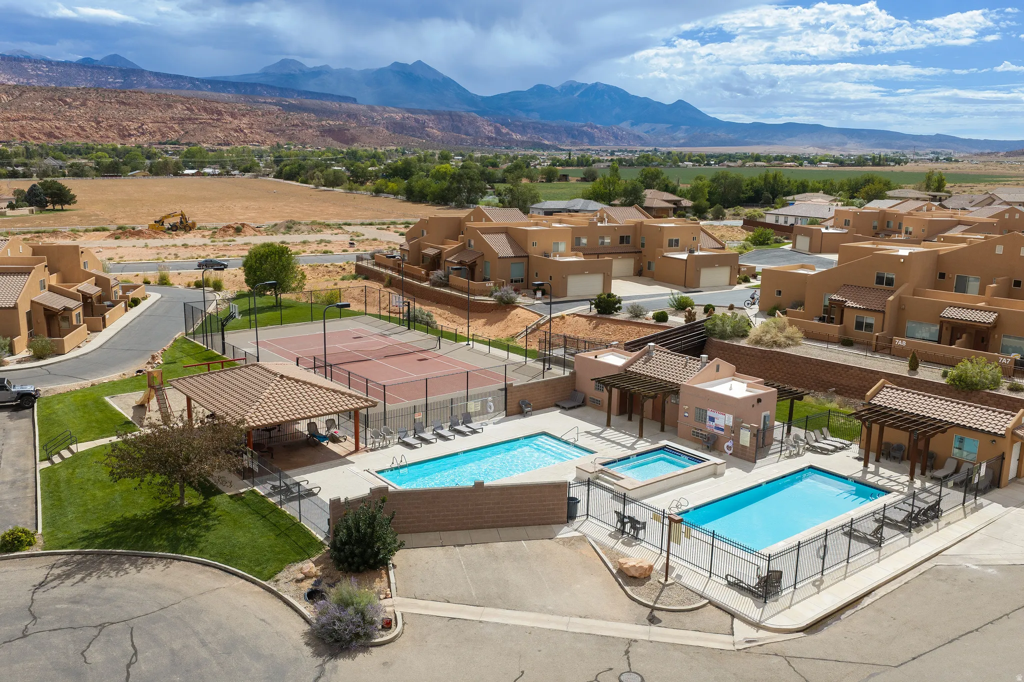 Community amenities featuring two swimming pools, a hot tub, two tennis courts, and covered outdoor seating areas