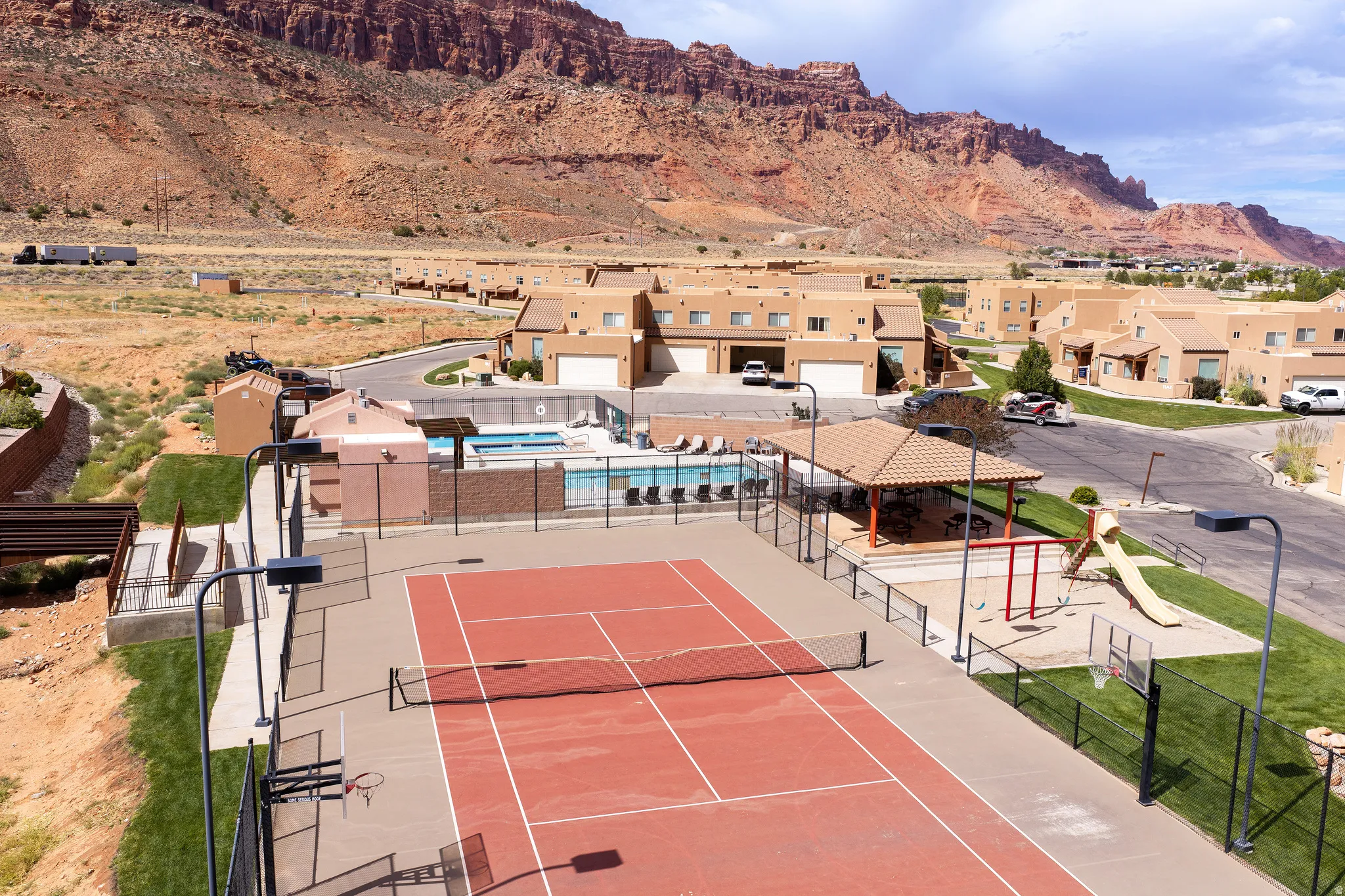 Community amenities featuring a tennis court, a swimming pool, and a playground