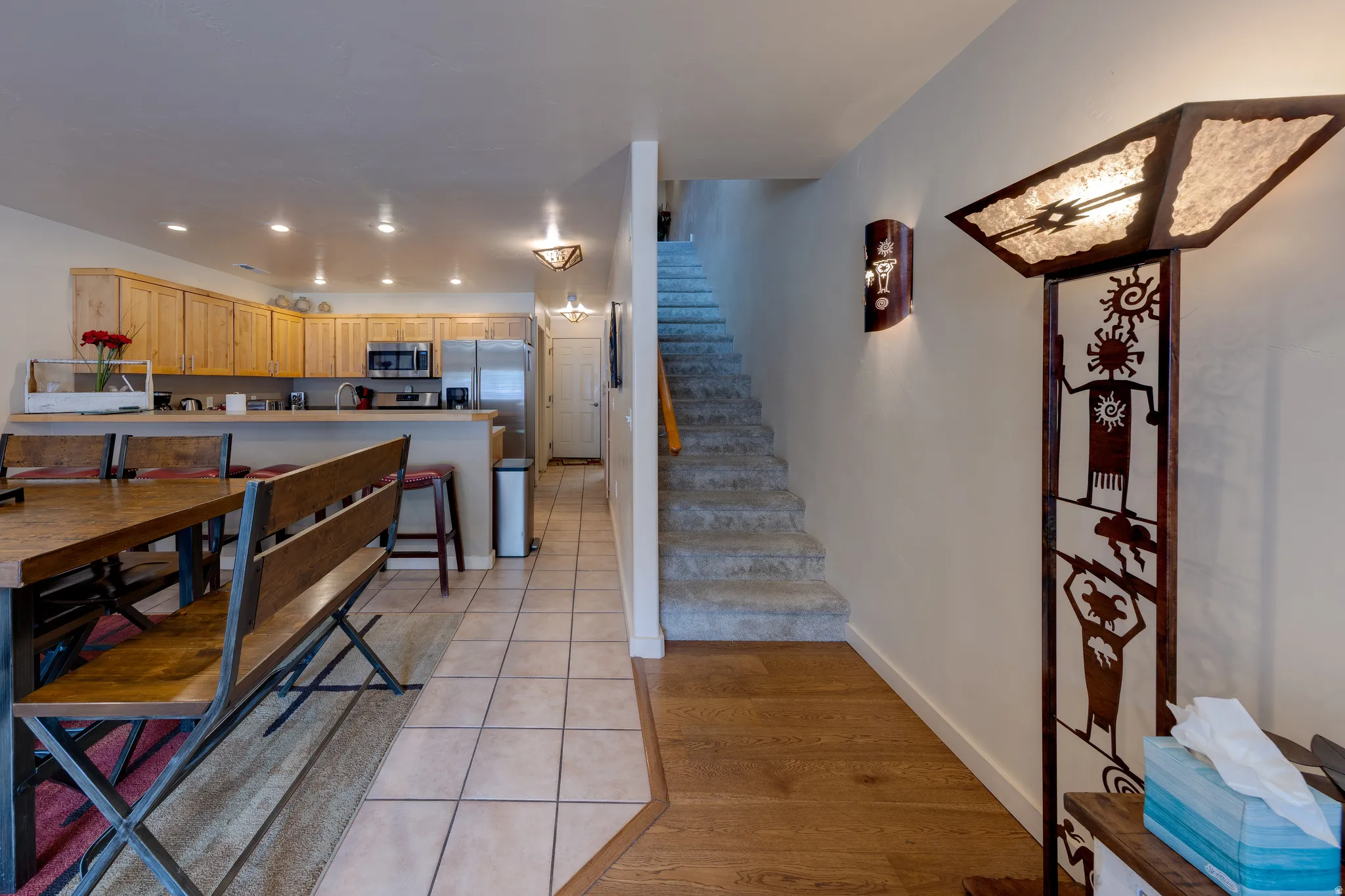 Kitchen area featuring wood-finish cabinetry, stainless steel appliances, and recessed lighting