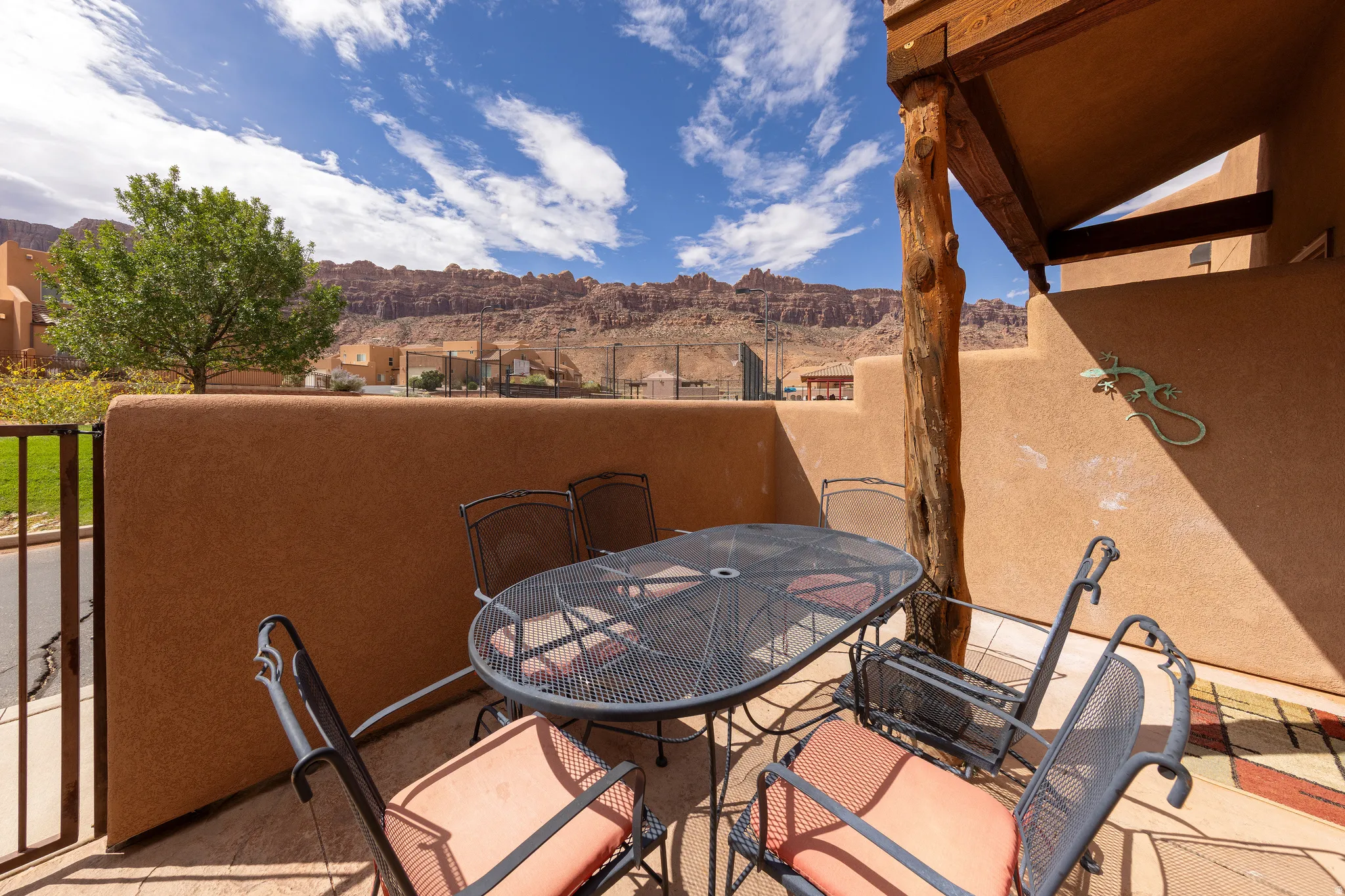 Private outdoor patio with stucco walls and wood beam accents