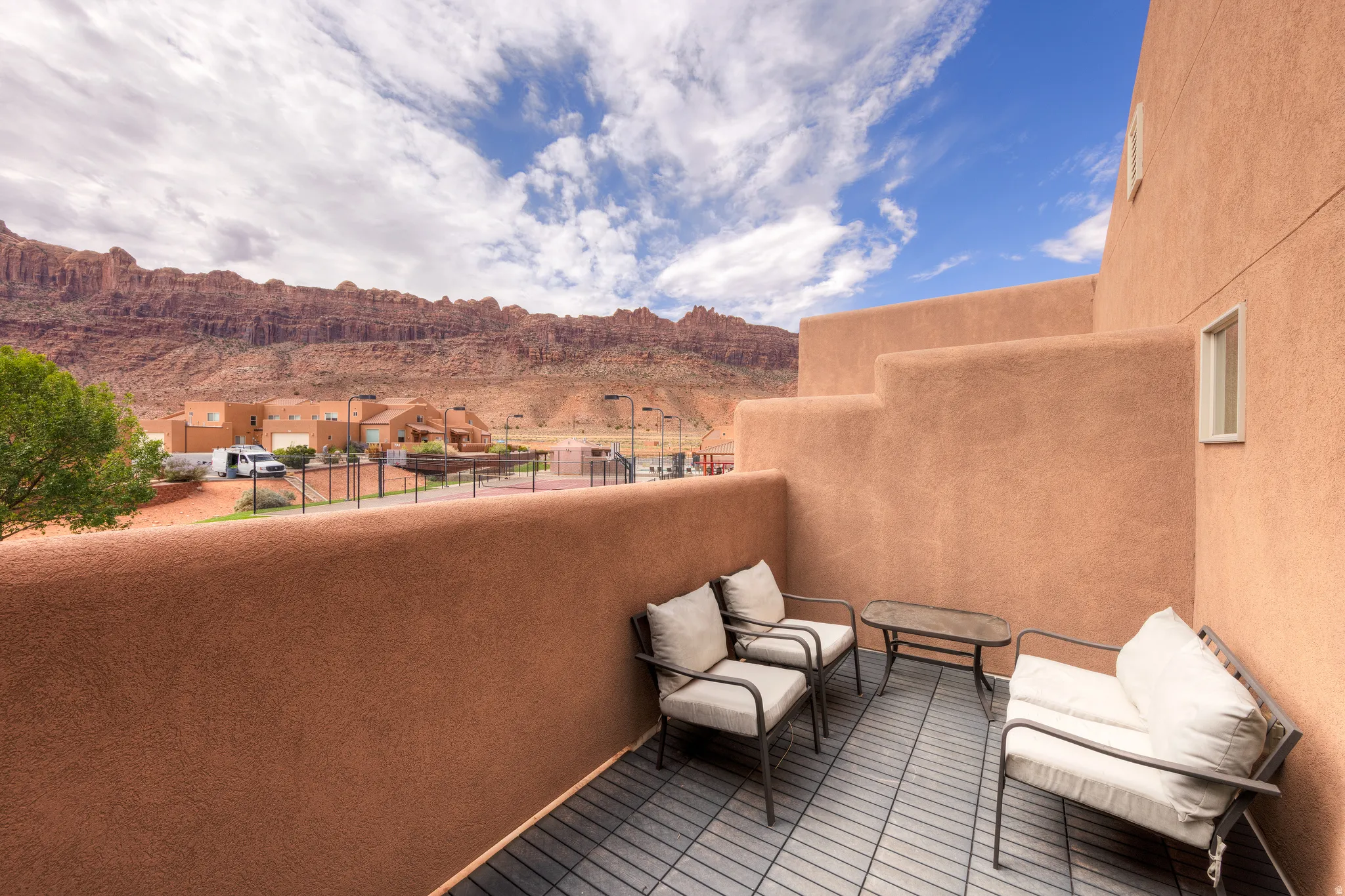 Terrace balcony with durable outdoor tile flooring and stucco exterior walls