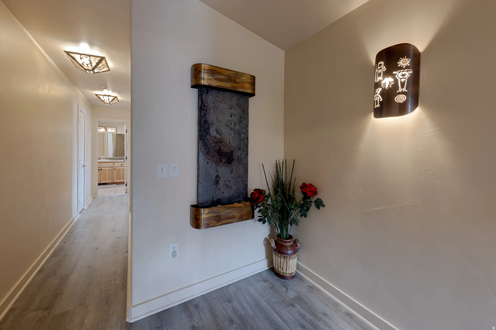 Wall-mounted water feature with a stone facade