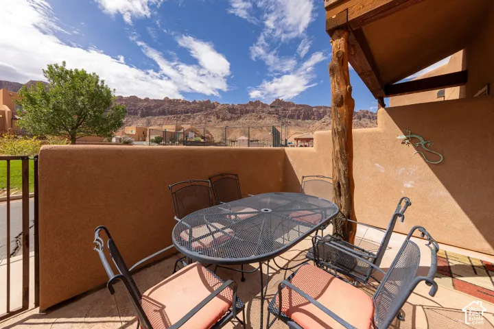 Private outdoor patio with stucco walls and wood beam accents
