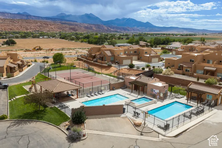 Community amenities featuring two swimming pools, a hot tub, two tennis courts, and covered outdoor seating areas