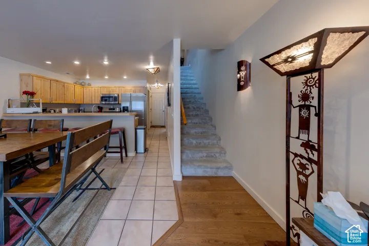 Kitchen area featuring wood-finish cabinetry, stainless steel appliances, and recessed lighting