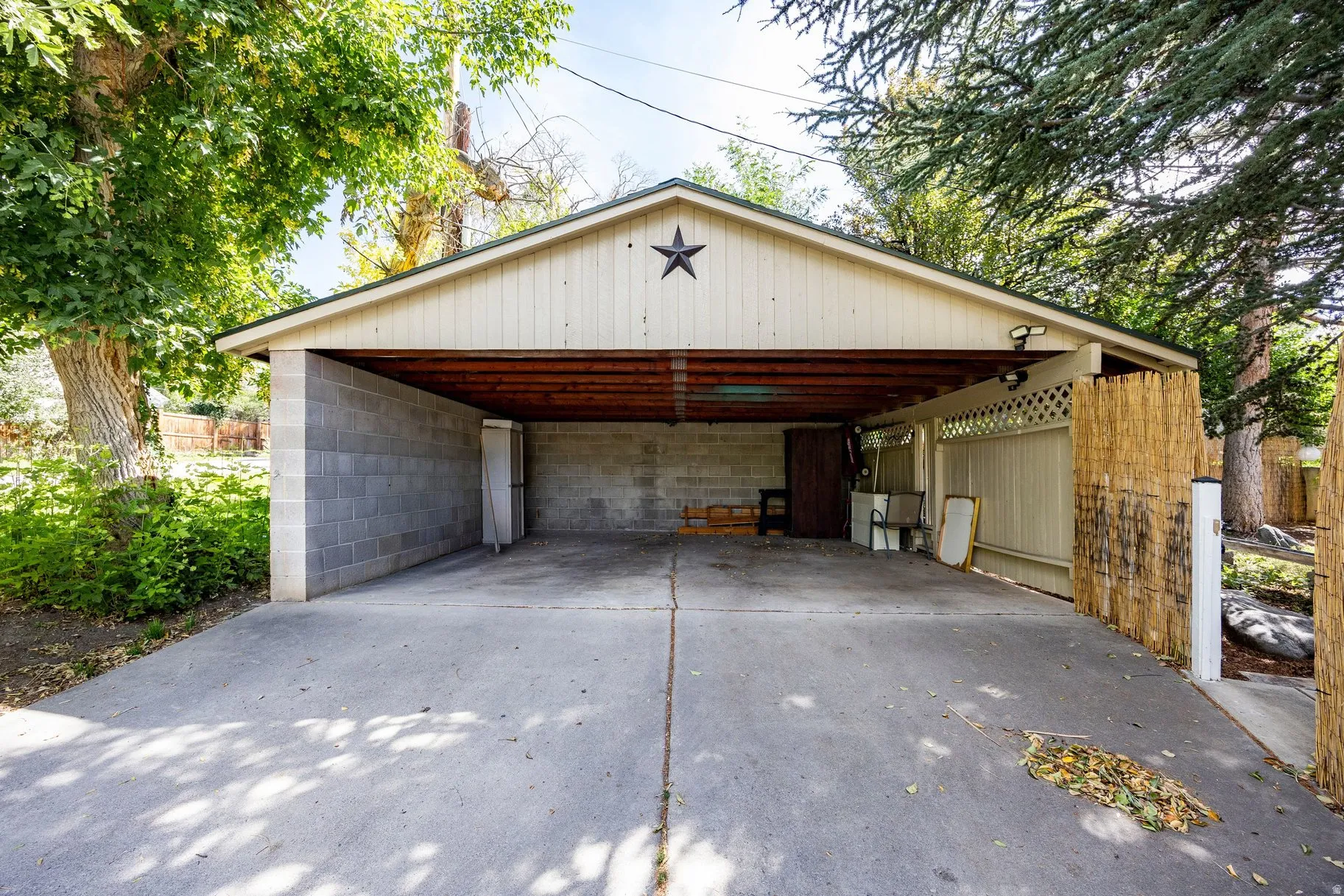 Concrete block carport with a wood-finish soffit and concrete driveway