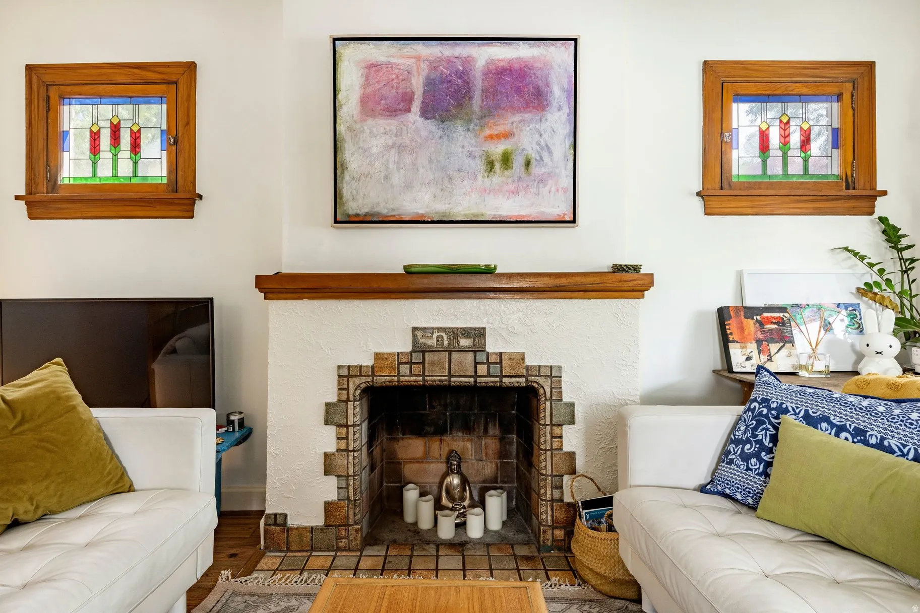 Art Deco-inspired fireplace with tile surround and wood mantel