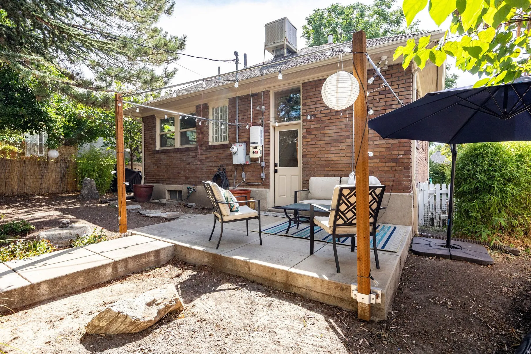 Patio with a concrete surface and brick exterior