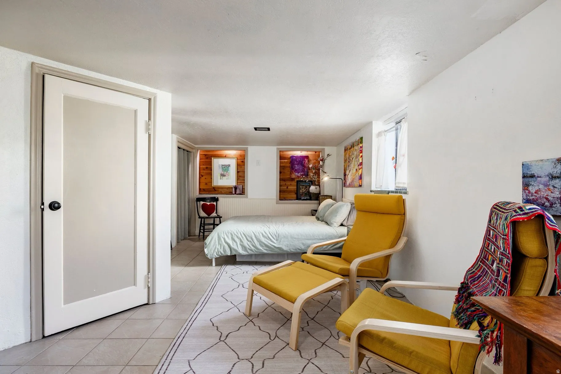 Tile flooring throughout with a partial area rug