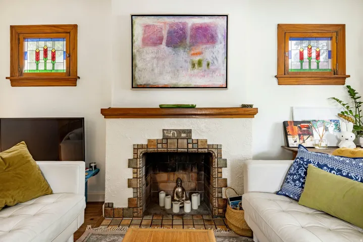 Art Deco-inspired fireplace with tile surround and wood mantel