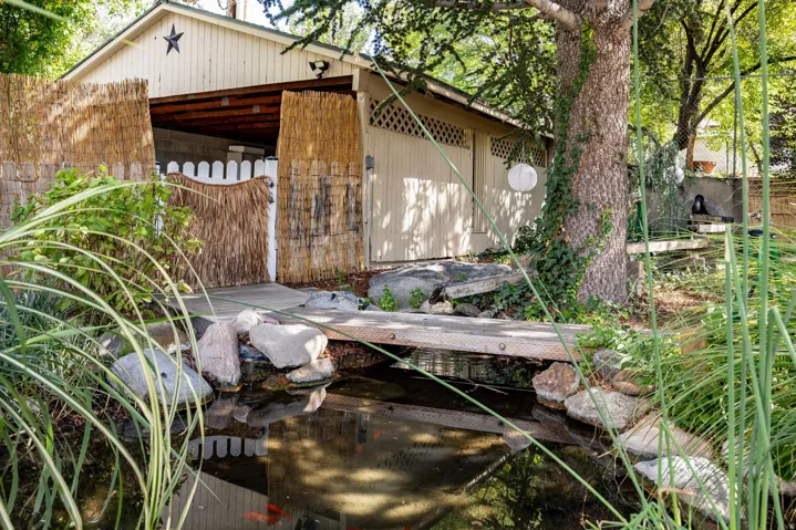 Water feature with a bridge and natural rock landscaping