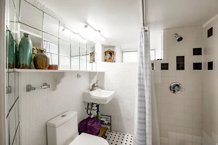 White subway tile shower surround with black accent tiles