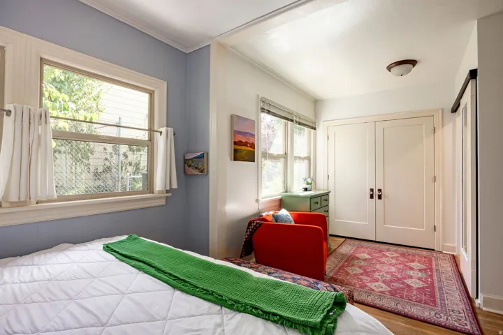 Hardwood-style flooring, dual pane windows, and a sliding barn door entry