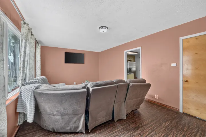 Wood-finish flooring, recessed ceiling lighting, and a white interior door frame