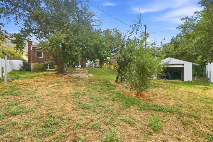 Expansive backyard with a detached garage and mature trees