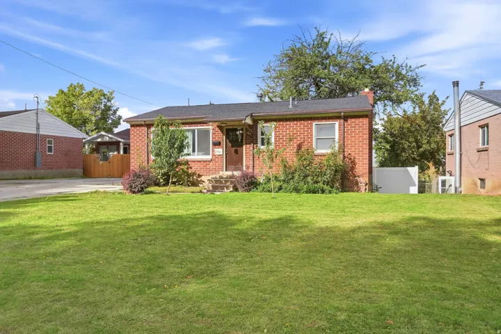 Brick exterior with a dark shingled roof