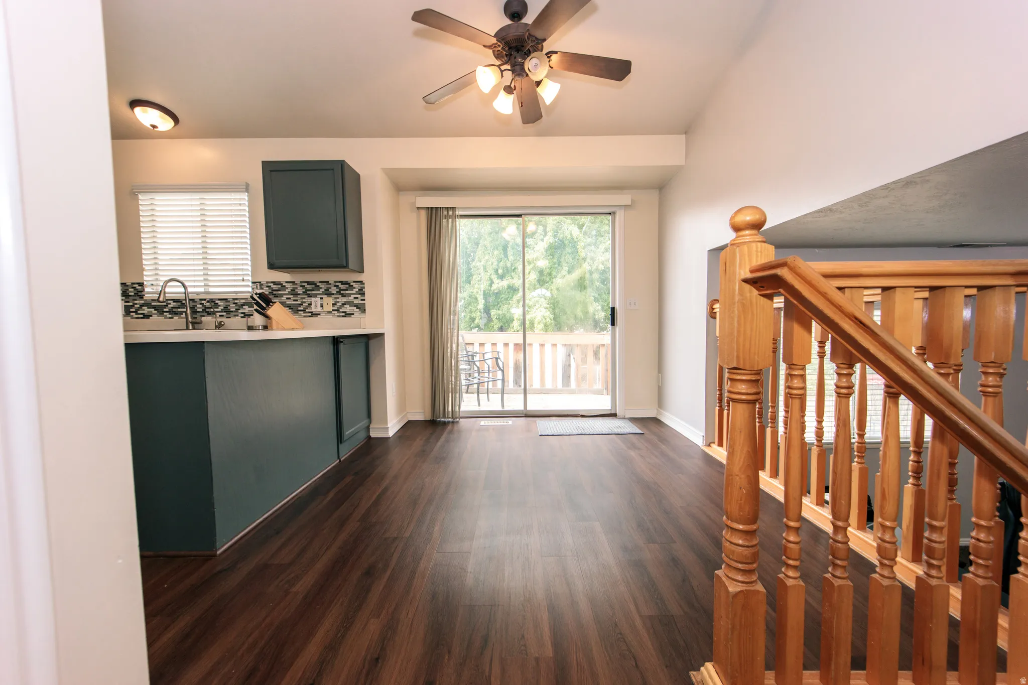 Wood-finish flooring throughout, vaulted ceiling, and direct access to an outdoor deck