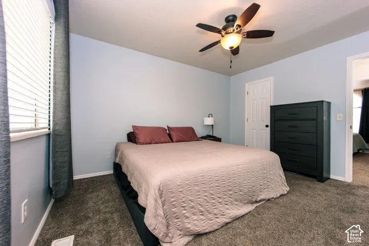 Wall-to-wall carpeting, ceiling fan with integrated lighting, and painted walls