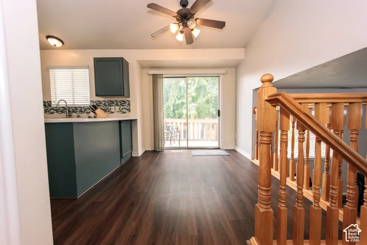 Wood-finish flooring throughout, vaulted ceiling, and direct access to an outdoor deck