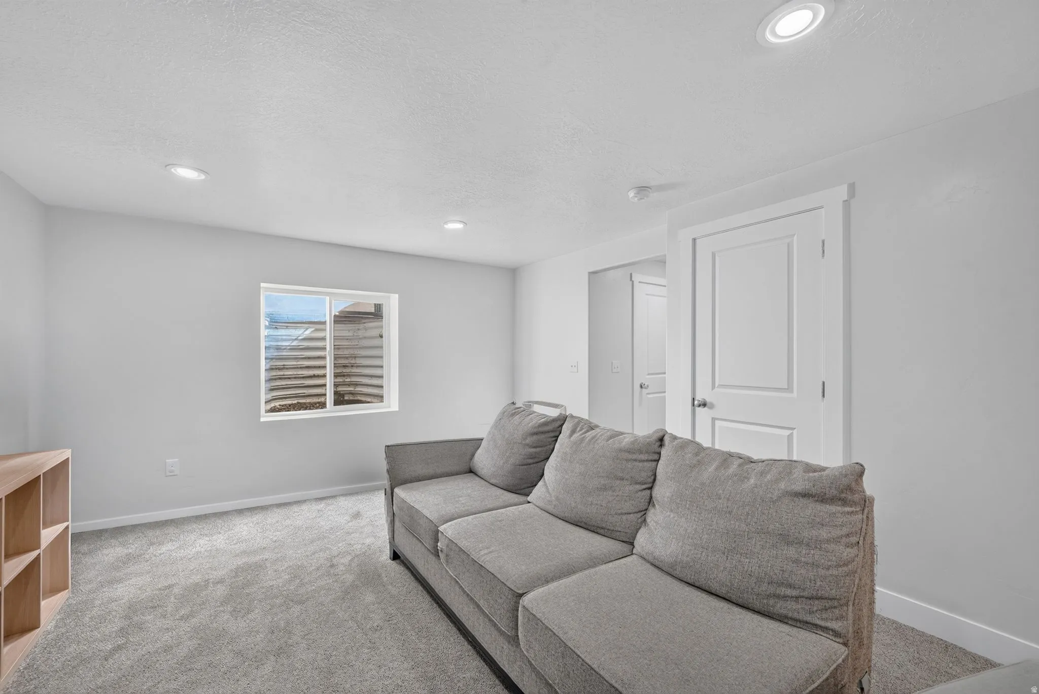 Recessed lighting, light gray carpet, and white interior doors