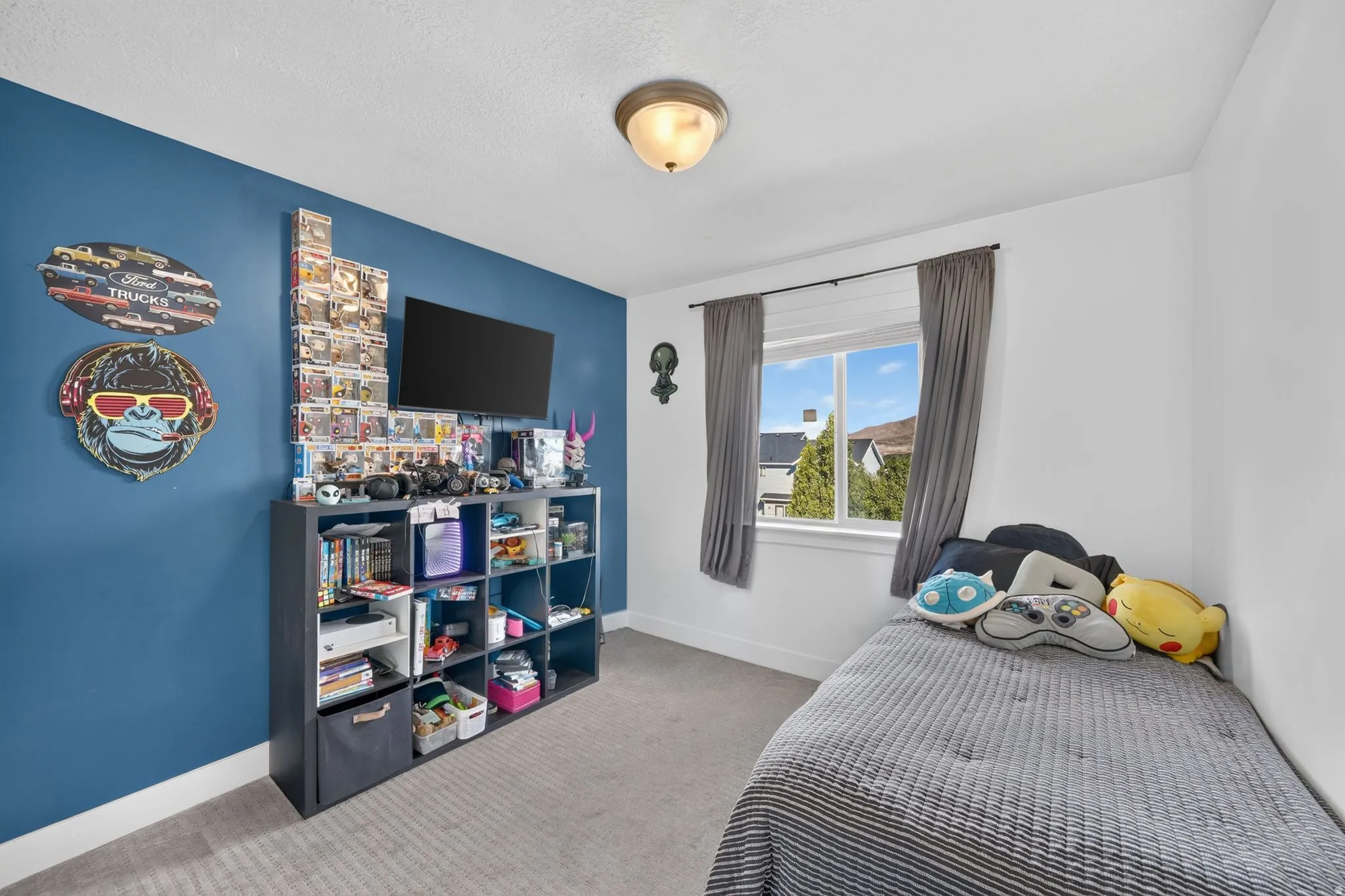 Recessed window with gray drapery, central ceiling light fixture, and blue accent wall