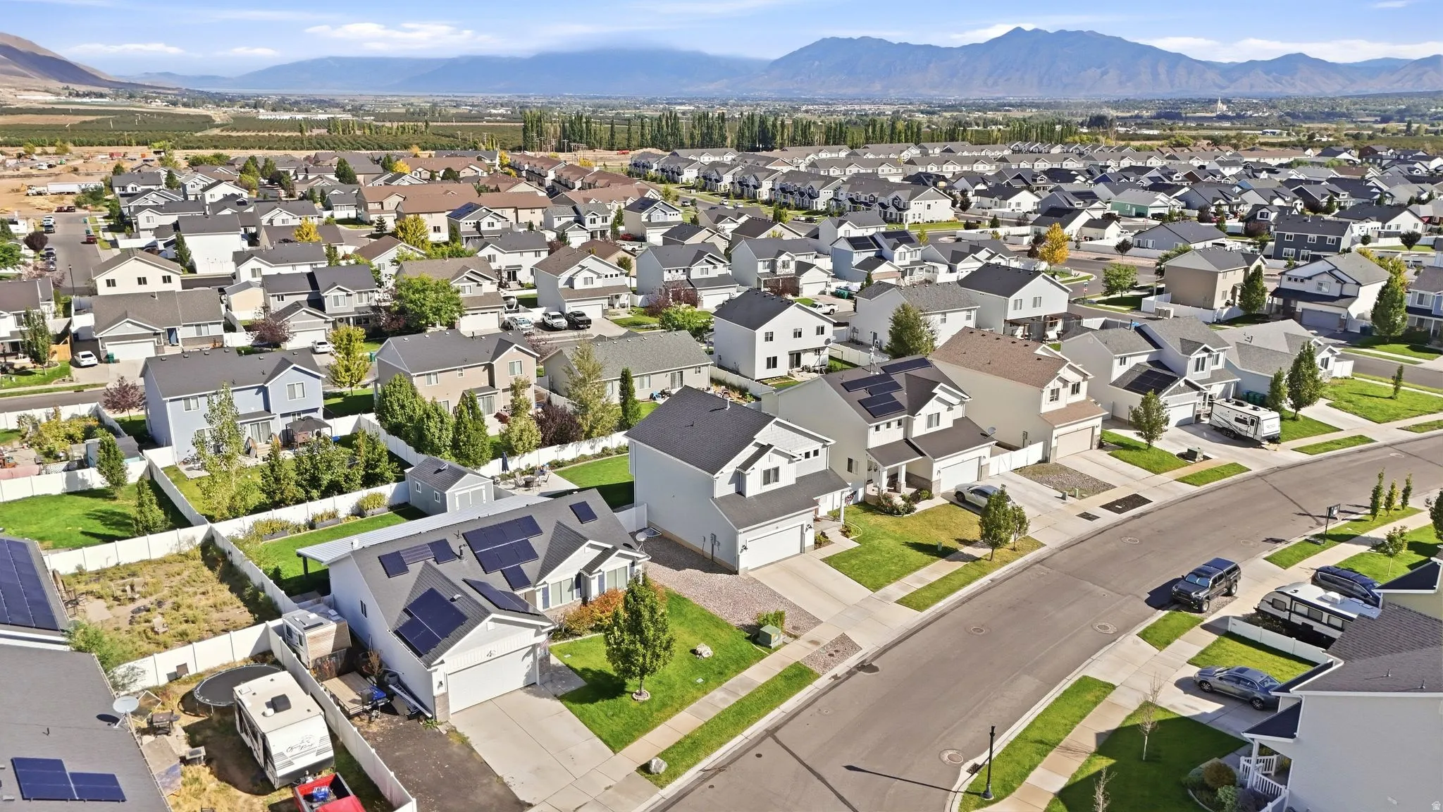 Expansive residential neighborhood with mature landscaping and mountain backdrop