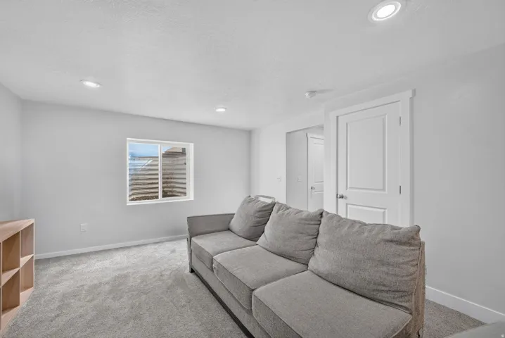 Recessed lighting, light gray carpet, and white interior doors