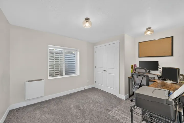 Neutral wall color, wall-mounted heater, double panel doors, and recessed lighting