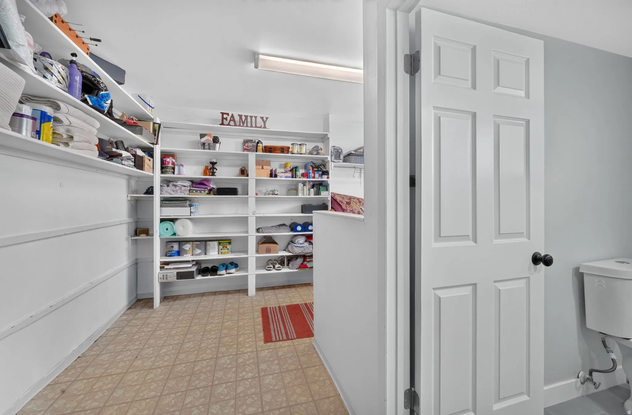 Built-in shelving units, recessed lighting, and tile flooring