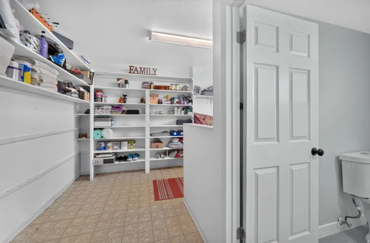 Built-in shelving units, recessed lighting, and tile flooring