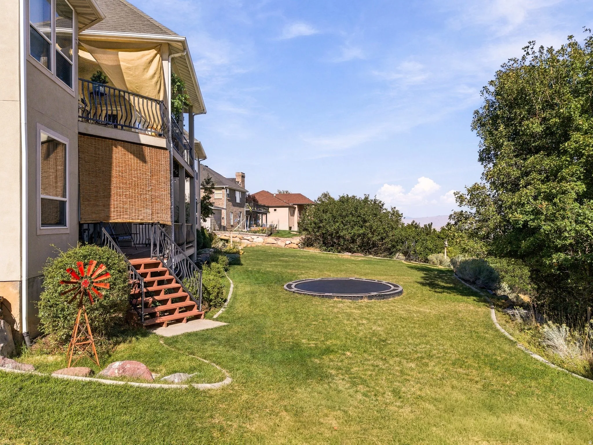Expansive green lawn with established shrubbery