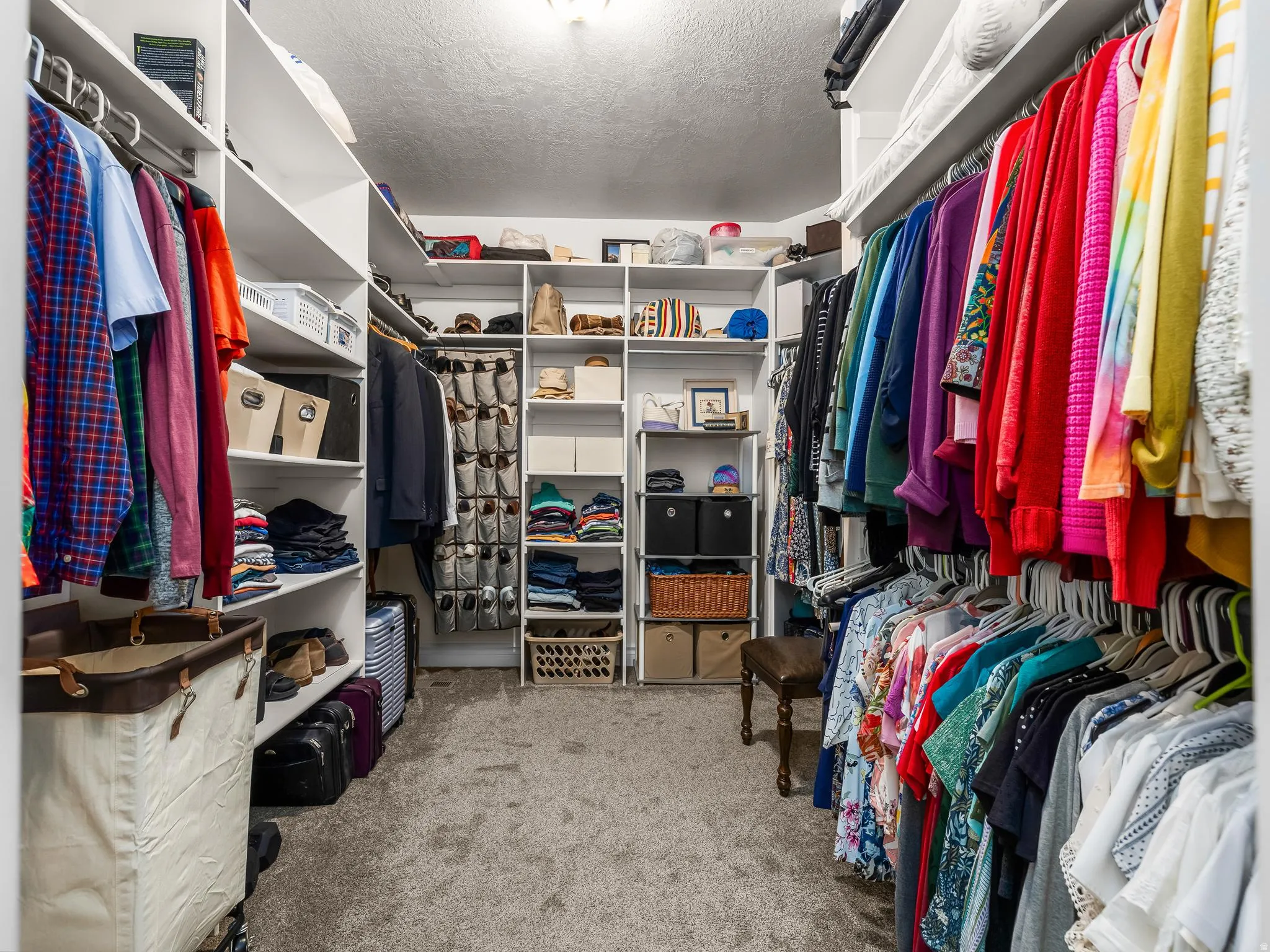 Customizable closet system with extensive shelving, multiple hanging rods, and integrated storage solutions