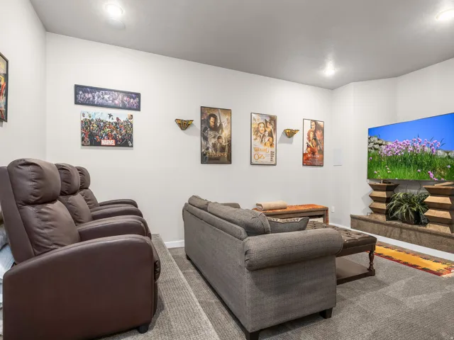 Recessed lighting illuminates this room featuring wall-to-wall carpeting