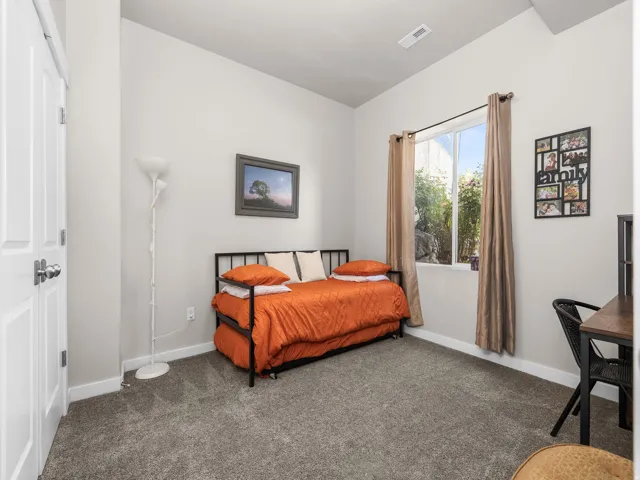 Plush carpeting, neutral wall colors, and a window with natural light