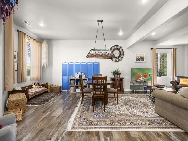 Wood-finish flooring, recessed lighting, and a pendant light fixture