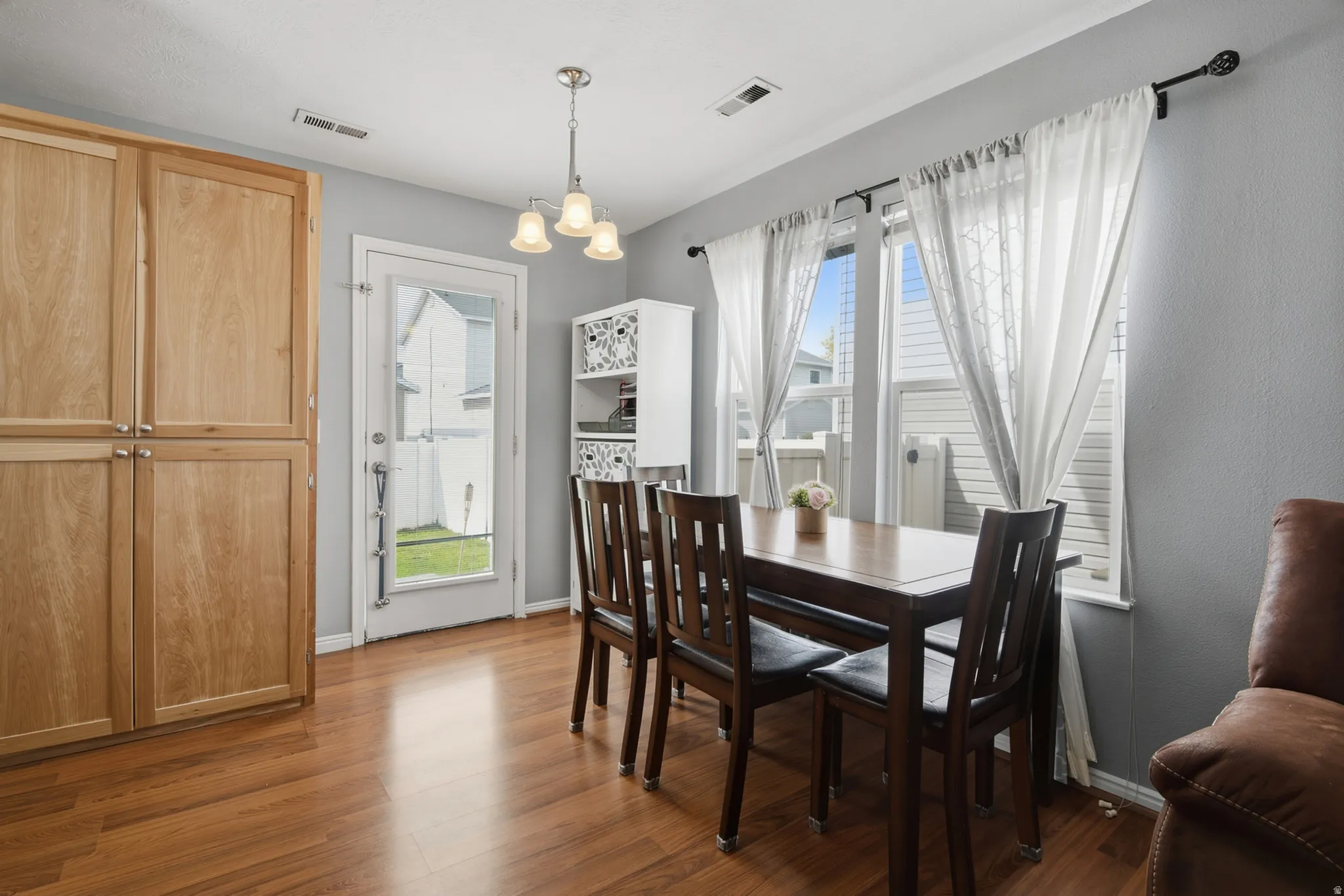 Hardwood flooring throughout, with a built-in wood-finish cabinet